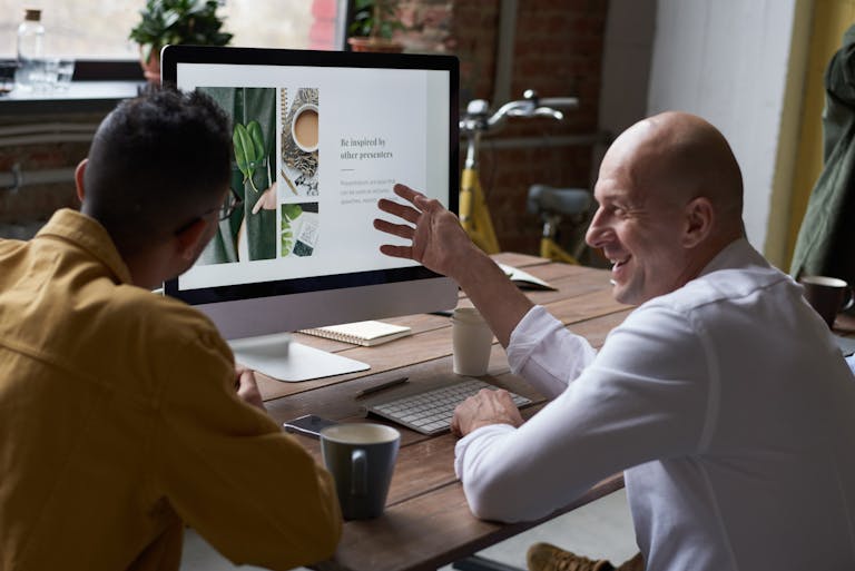 Photo Of People Sitting In Front Of Computer